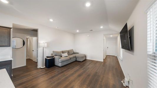 Living room with dark wood-type flooring