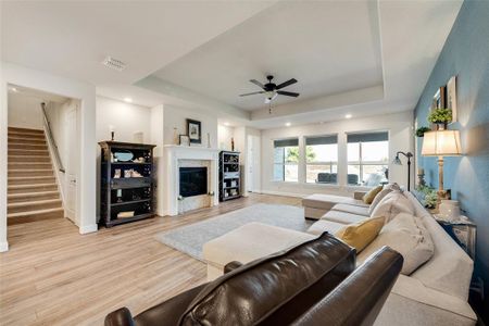 Open living room with pop-up ceiling & abundant natural light