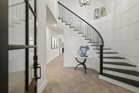 Entry Foyer with beautiful wrought iron staircase with wood treds and wall panelings.