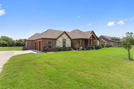 View of front of home featuring a garage and a front yard