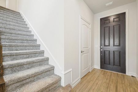 Foyer entrance featuring light hardwood / wood-style floors