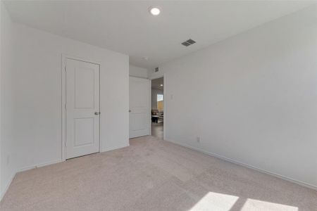 Unfurnished bedroom with light carpet