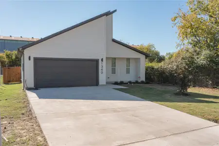 View of front of home featuring a garage and a front lawn