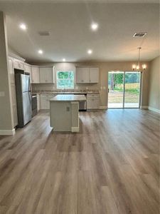 Open floor plan kitchen, dining area and living room