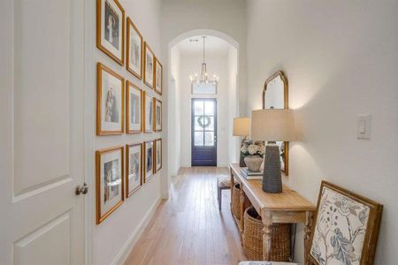 Foyer with a chandelier and light hardwood / wood-style floors