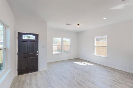 Entrance with plenty of natural light and light wood-type flooring