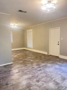 Empty room featuring dark wood-type flooring