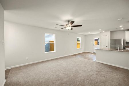 The spacious living room, open to the kitchen and dining area.