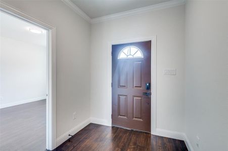 Foyer entrance featuring ornamental molding and hardwood / wood-style flooring