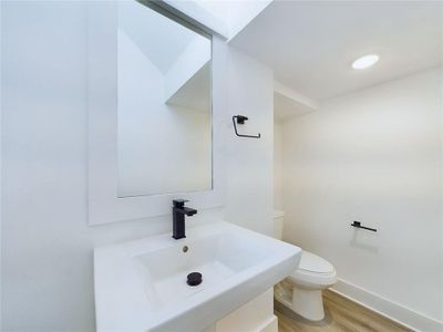 Powder room conveniently located on the first floor. Model home photos
