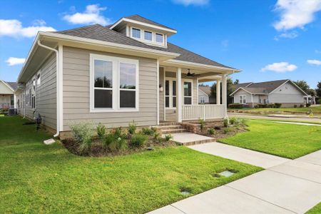 View of front facade featuring a porch, a front lawn, ceiling fan, and cooling unit