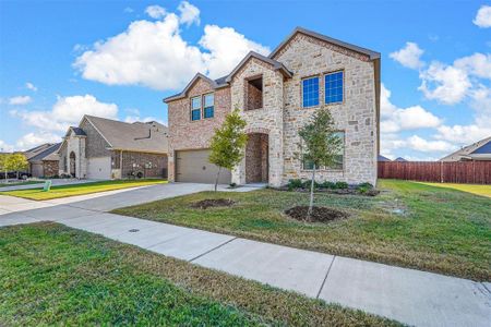 View of front of home featuring a front lawn and a garage