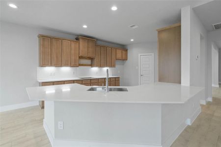 This kitchen is by far any chef’s dream! This spacious kitchen features high ceilings, stained wood cabinets, quartz countertops, SS appliances, modern tile backsplash, recessed lighting, extended counter space, extra space for breakfast bar, and a walk-in pantry all overlooking your huge family room.