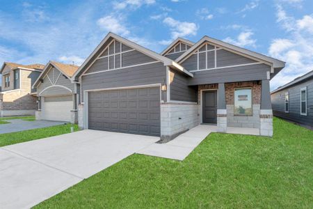 Stunning curb appeal greets you at this brand-new home by Saratoga Homes in Aldine Pines. The modern exterior design, complete with clean lines and a spacious two-car garage, sets the stage for the luxury that awaits inside. The inviting entrance offers a warm welcome, perfect for homeowners who appreciate style and comfort. **This image is from another Saratoga Home - Clover floorplan.**