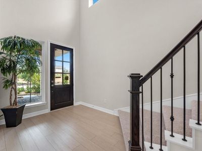 Foyer featuring a high ceiling and light hardwood / wood-style floors