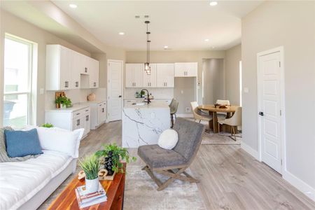 Living room featuring sink, plenty of natural light, and light hardwood / wood-style flooring