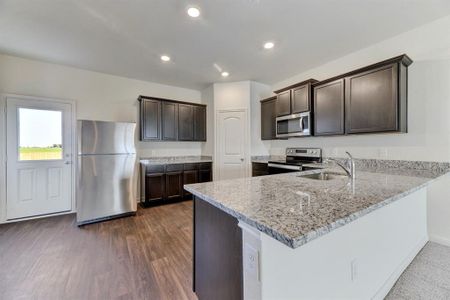 Stainless steel energy-efficient kitchen appliances - including refrigerator with ice-maker, granite countertops and luxury vinyl plank flooring are included in this chef ready kitchen.