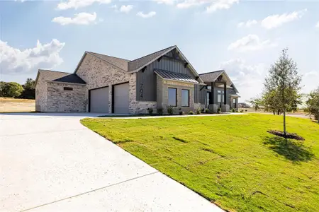 View of front of home featuring a garage and a front lawn