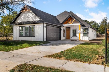 Modern farmhouse style home with a front yard and a garage