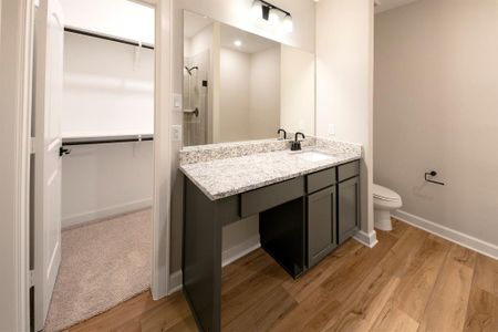 Even the bathrooms have granite countertops and a vanity space with a slot for a stool.