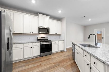 The kitchen comes stocked with  Whirlpool kitchen appliances and beautiful granite countertops.