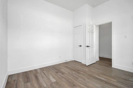 Bedroom number one with a spacious closet and tile flooring.