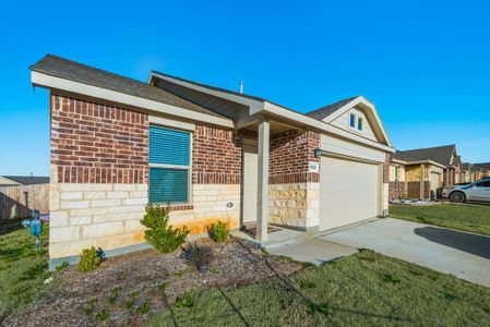 Single story home with a garage and a front yard