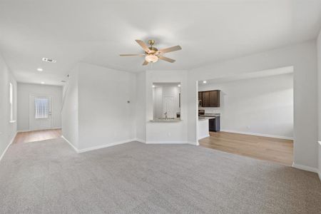 Unfurnished living room with light hardwood / wood-style floors, sink, and ceiling fan