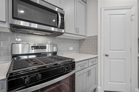 Kitchen featuring tasteful backsplash and appliances with stainless steel finishes