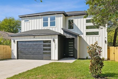 View of front of home featuring a garage and a front lawn