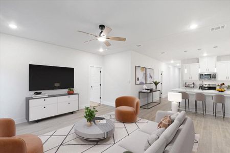 Living room with ceiling fan and light wood-type flooring