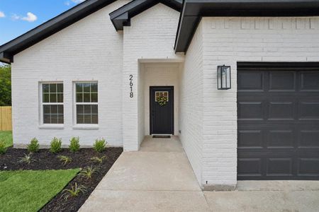 View of exterior entry with a 2 car garage