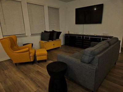 Living room with dark hardwood / wood-style flooring