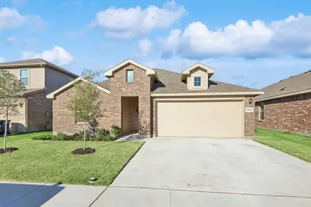 View of front of house with a front lawn and a garage