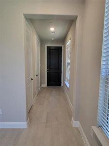 Corridor with light hardwood / wood-style floors