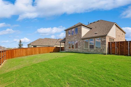 Back of house with a yard