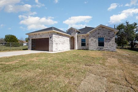 View of front of house featuring a garage and a front lawn