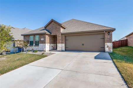 View of front of house with a front yard and a garage