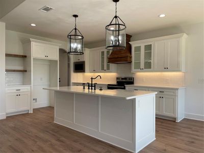 Kitchen featuring white cabinetry, tasteful backsplash, dark wood-type flooring, and stove