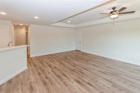 Unfurnished room featuring ceiling fan and light hardwood / wood-style flooring