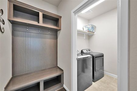 Just off the 3 car tandem garage is a mudroom that strategically leads into your laundry room.  The mudroom provides ample storage space for backpacks, jackets, shoes, etc. while the laundry room is spacious and has shelving for storing laundry supplies.