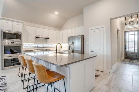 Large dining bar and island with built in sink and granite countertops