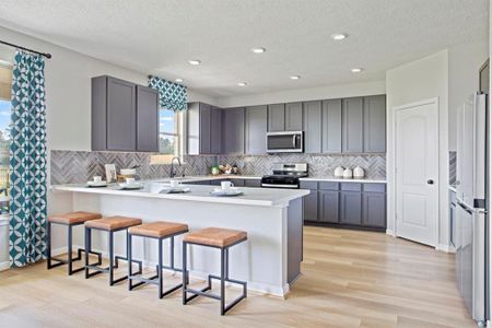 This stunning kitchen displays such a beautiful overall look with the grey stained cabinets, custom neutral paint, silestone countertops, modern backsplash, SS appliances, extended kitchen counterspace, recessed lighting, high ceilings, and walk in pantry!