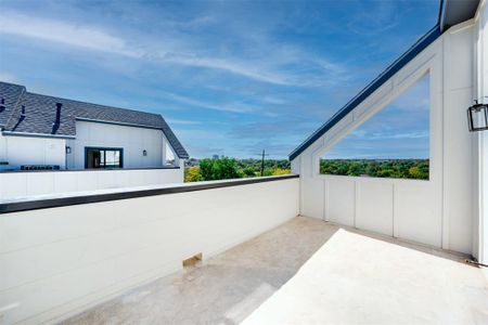 View of patio with a balcony