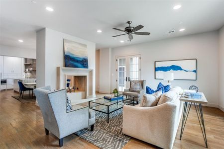 Living room featuring ceiling fan, french doors, and hardwood / wood-style flooring