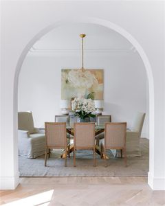 Dining room featuring crown molding, a notable chandelier, and hardwood / wood-style floors