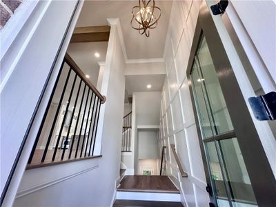 Entry foyer showcases two story wall trim to elevate your space