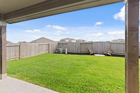 Step out onto the sheltered patio and embrace the expansive, lush backyard oasis, perfect for relaxation and entertainment.