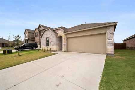 View of front of home featuring a front yard and a garage