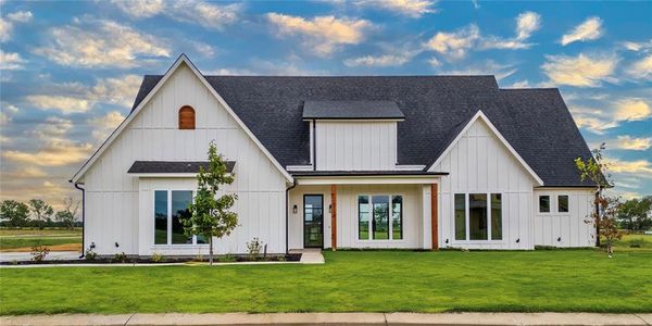 Modern farmhouse style home with a front yard